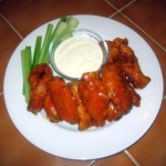 A plate of Buffalo Wings with Celery and Blue Cheese Dressing